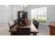 Traditional dining room with dark wood table and large window at 5890 Sw 83Rd St, Ocala, FL 34476