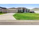 Charming single-story home with a well-manicured lawn and neutral-toned exterior at 5890 Sw 83Rd St, Ocala, FL 34476