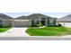 Attractive one-story home featuring green lawn, a two-car garage, driveway, and simple landscaping at 5890 Sw 83Rd St, Ocala, FL 34476