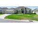 Charming one-story home featuring green lawn, a two-car garage, and simple landscaping at 5890 Sw 83Rd St, Ocala, FL 34476