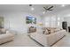 Bright living room with modern tile floors, ceiling fan and a contemporary sectional sofa at 5890 Sw 83Rd St, Ocala, FL 34476
