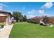 Spacious backyard with green grass, landscaping, and mature trees, providing a private and serene outdoor space at 6104 Hunters Ridge Ave, Leesburg, FL 34748