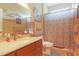 Functional bathroom featuring a vanity with a sink, a mirror, and a shower with a decorative curtain at 6104 Hunters Ridge Ave, Leesburg, FL 34748