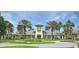 Grand community clubhouse with beautiful landscaping, palm trees, and circular driveway, perfect for community events at 6104 Hunters Ridge Ave, Leesburg, FL 34748