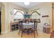 Charming dining area featuring tile flooring, a round table with seating, and two windows for natural light at 6104 Hunters Ridge Ave, Leesburg, FL 34748