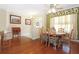 Cozy dining area adjacent to the living room with hardwood floors and ample lighting at 6104 Hunters Ridge Ave, Leesburg, FL 34748