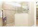 Tiled shower with glass partition and a built-in shelf for toiletries, offering a clean and modern design at 6104 Hunters Ridge Ave, Leesburg, FL 34748