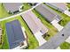 Aerial view of house highlighting the roof, driveway, and green lawn at 6471 Ecoff Pl, The Villages, FL 34762