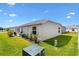 Well-maintained backyard with manicured landscaping, showcasing the home's exterior at 6471 Ecoff Pl, The Villages, FL 34762