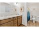 Charming bathroom featuring double sinks and a shower with a blue accent curtain at 6471 Ecoff Pl, The Villages, FL 34762