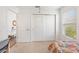 Bedroom showcasing closet, doorway, and window providing natural light with bright neutral walls at 6471 Ecoff Pl, The Villages, FL 34762