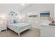 Comfortable bedroom featuring a ceiling fan and a beach painting at 6471 Ecoff Pl, The Villages, FL 34762