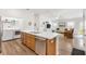 Gorgeous kitchen and living space, featuring stainless steel appliances, island with sink and lots of natural light at 6471 Ecoff Pl, The Villages, FL 34762