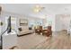 Bright living room featuring modern furniture, wood-look floors, and natural light at 6471 Ecoff Pl, The Villages, FL 34762