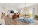 Cozy living room featuring stylish furniture and a dining area with sliding doors at 6471 Ecoff Pl, The Villages, FL 34762