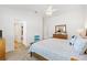 Light-filled main bedroom with a ceiling fan, carpet flooring, a dresser and ensuite bathroom at 6471 Ecoff Pl, The Villages, FL 34762