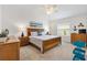 Cozy main bedroom featuring a ceiling fan, natural light, and coastal decor at 6471 Ecoff Pl, The Villages, FL 34762
