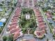 Stunning aerial view of the community showcasing the well-maintained homes, pool, and lush landscaping at 732 Ramirez Ave, The Villages, FL 32159