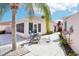 Wide angle shot of the backyard, featuring lush landscaping and outdoor seating at 732 Ramirez Ave, The Villages, FL 32159