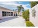 Landscaped backyard featuring a small patio area and access to an enclosed porch at 732 Ramirez Ave, The Villages, FL 32159
