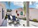 Private backyard area with chairs, landscaping and a tropical palm tree at 732 Ramirez Ave, The Villages, FL 32159