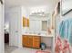 Bathroom boasts lots of light, mirror, and counterspace with tiled floors at 732 Ramirez Ave, The Villages, FL 32159