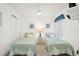 This guest bedroom is appointed with two beds, closet and is naturally lit at 732 Ramirez Ave, The Villages, FL 32159