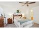 Light and airy primary bedroom features ceiling fan and natural light at 732 Ramirez Ave, The Villages, FL 32159