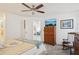 The primary bedroom includes a closet, TV, and a seating area by the window at 732 Ramirez Ave, The Villages, FL 32159