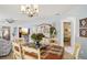 Charming dining area featuring an elegant chandelier and seamless access to the kitchen and living spaces at 732 Ramirez Ave, The Villages, FL 32159