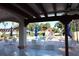 Relaxing poolside view from the covered patio, featuring comfortable seating and lush landscaping at 732 Ramirez Ave, The Villages, FL 32159