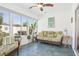 The sunroom offers beautiful decor, windows to let the sunshine in, and comfortable seating at 732 Ramirez Ave, The Villages, FL 32159