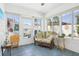 The sunroom provides access to the backyard and is surrounded by windows at 732 Ramirez Ave, The Villages, FL 32159