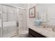 Bright bathroom featuring a glass shower, granite vanity and chrome hardware at 8024 Oak Shadow Ct, Davenport, FL 33837