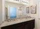 Elegant bathroom with double sinks, granite countertops, and a well-lit vanity mirror at 8024 Oak Shadow Ct, Davenport, FL 33837