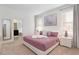 Bright and airy bedroom with comfortable bed, and a view of the ensuite bathroom at 8024 Oak Shadow Ct, Davenport, FL 33837