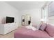 Inviting bedroom with a swan towel decoration on a purple bed at 8024 Oak Shadow Ct, Davenport, FL 33837