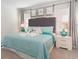 Comfortable bedroom featuring a queen bed, bedside lamps, and stylish decor at 8024 Oak Shadow Ct, Davenport, FL 33837