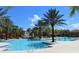 Full view of sparkling community pool complete with waterfall feature and water slide at 8024 Oak Shadow Ct, Davenport, FL 33837