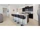 Eat-in kitchen features an island with seating, modern lighting, and stainless appliances at 8024 Oak Shadow Ct, Davenport, FL 33837