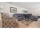 Relaxing living area with a large sectional sofa and glass coffee table, perfect for Gathering time at 8024 Oak Shadow Ct, Davenport, FL 33837