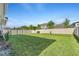 Spacious backyard with green grass and privacy fence, perfect for outdoor activities at 8272 Procida Isle Ln, Windermere, FL 34786