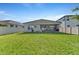 Lush green backyard with a white fence and screened patio, perfect for outdoor enjoyment at 8272 Procida Isle Ln, Windermere, FL 34786