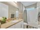 Bathroom featuring a white vanity with a large mirror, and a shower-tub combination with white tile surround at 8272 Procida Isle Ln, Windermere, FL 34786