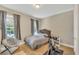 Cozy bedroom with a large bed and hardwood floors, illuminated by natural light from the windows at 8272 Procida Isle Ln, Windermere, FL 34786
