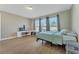 Comfortable bedroom featuring tiled flooring, large windows, and a desk area with a chair at 8272 Procida Isle Ln, Windermere, FL 34786