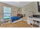 Fun bedroom featuring a unique space-themed bed, a desk, and a fish tank near the window at 8272 Procida Isle Ln, Windermere, FL 34786