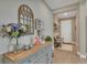 Inviting entryway with a stylish wooden console table decorated with flowers and decorative objects at 8272 Procida Isle Ln, Windermere, FL 34786