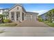 Charming home with a two-car garage, brick-paved driveway, and well-maintained landscaping at 8272 Procida Isle Ln, Windermere, FL 34786