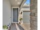 Stylish front entrance featuring a gray door, brick accents, and well-maintained landscaping at 8272 Procida Isle Ln, Windermere, FL 34786
